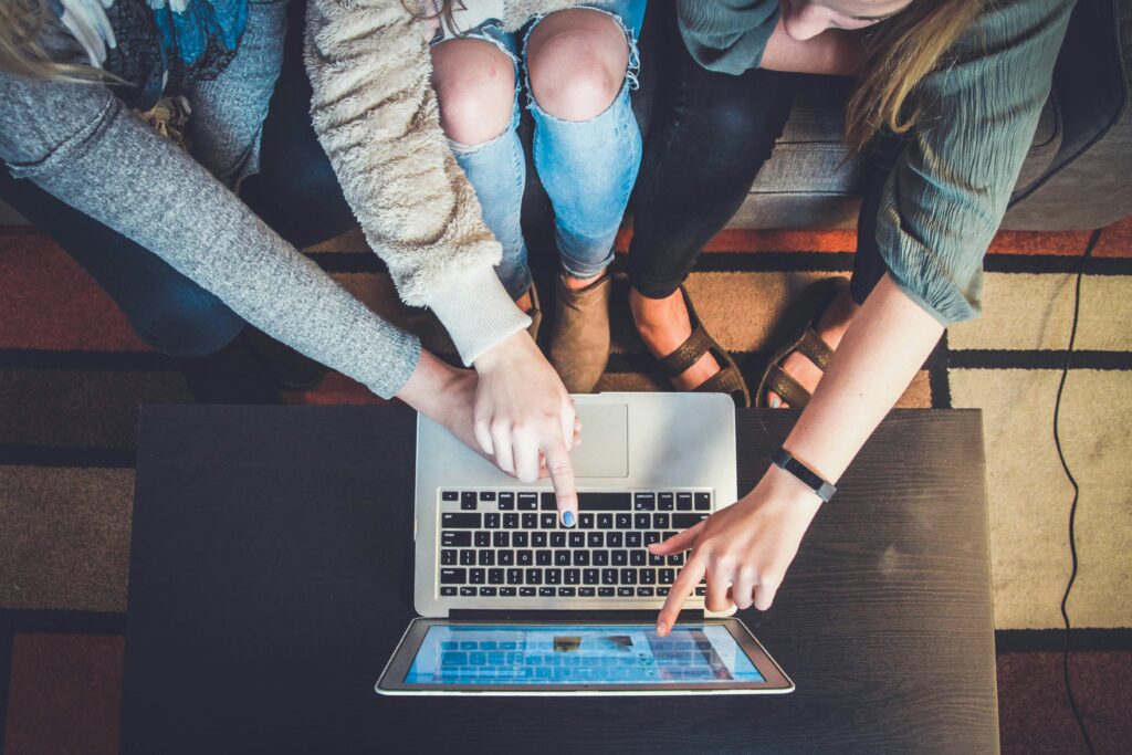 Group pointing at laptop screen